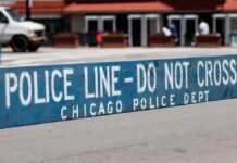 Police barricade with 'Do Not Cross' message in urban street