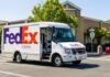 FedEx delivery truck driving on a city street