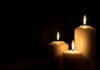 Father’s Plea Reveals A Funeral Cost Crisis Three lit candles against a dark background
