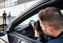 Photographer in car taking pictures of couple walking