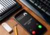 smartphone on desk showing an incoming anonymous call