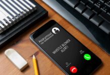 Trump’s Fraud Tip Plan Faces Tough Questions smartphone on desk showing an incoming anonymous call