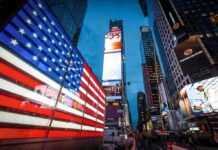 Legal Heat Builds Over Patriotic Ads American flag LED display in Times Square at dusk