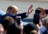 Shock Invite: Trump Woos Democrat Senator Donald Trump waves to a crowd while walking past onlookers