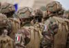 Prime Minister Hesitates As France Burns Soldiers in camouflage uniforms wearing helmets and body armor