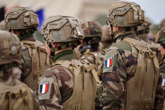 shutterstock_2155320783 Soldiers in camouflage uniforms wearing helmets and body armor