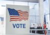 Election Chaos Warning Ignites – Proof Or Hype? Voting booth with American flag design in a modern polling place