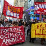 Shock Move: Dems Swear Off Socialism Protesters holding large banners at a city street demonstration