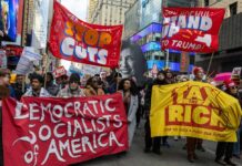 Shock Move: Dems Swear Off Socialism Protesters holding large banners at a city street demonstration