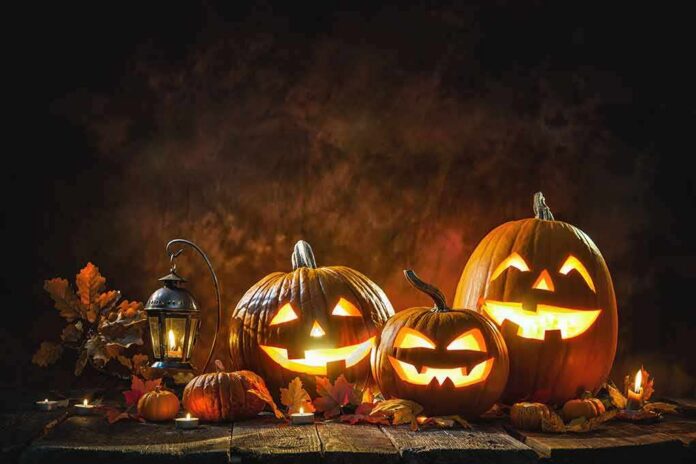 Jack-o'-lantern pumpkins glowing on a rustic table