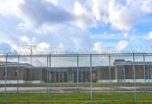 Surveillance Trail Traps Alleged Firebomber Prison yard behind chain-link and razor wire fence