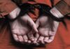 Public Execution Shock From Pentagon person in handcuffs with hands behind back