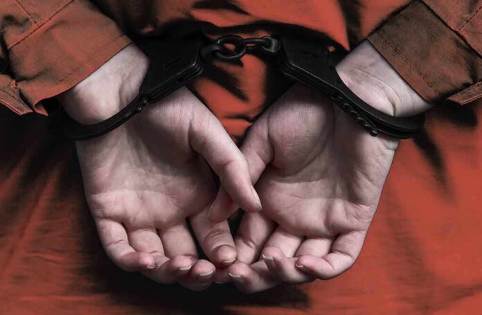 shutterstock_795931975-1 person in handcuffs with hands behind back